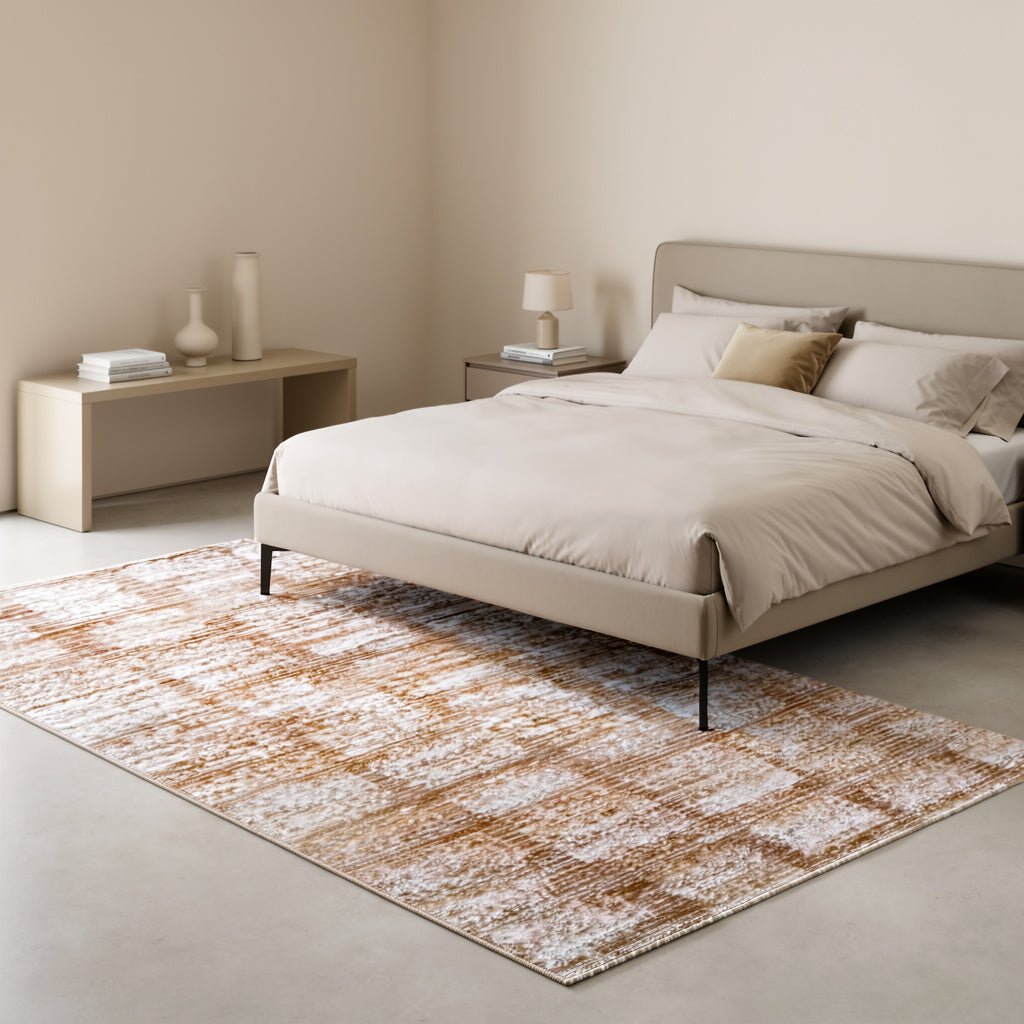 Minimalist bedroom with beige upholstered bed, neutral bedding, patterned rug, and simple decor