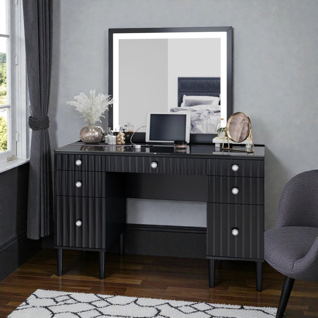 Black modern vanity desk with mirror, decorative vase, tablet, and round mirror in cozy bedroom
