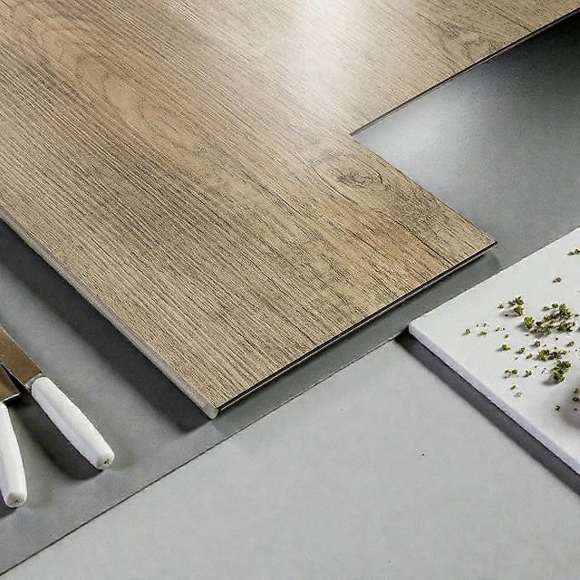 Wooden plank flooring sample with gray and white kitchen tools and herbs on light gray surface