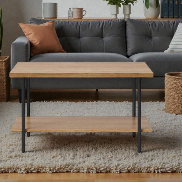 Modern living room with wooden coffee table on shag rug and gray tufted sofa with orange pillow