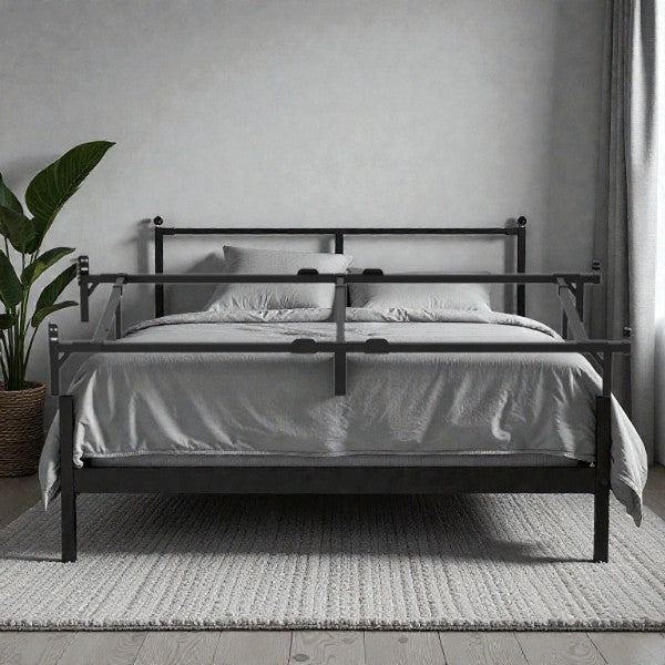 Modern black metal bed frame with safety rails and gray bedding in minimalist bedroom